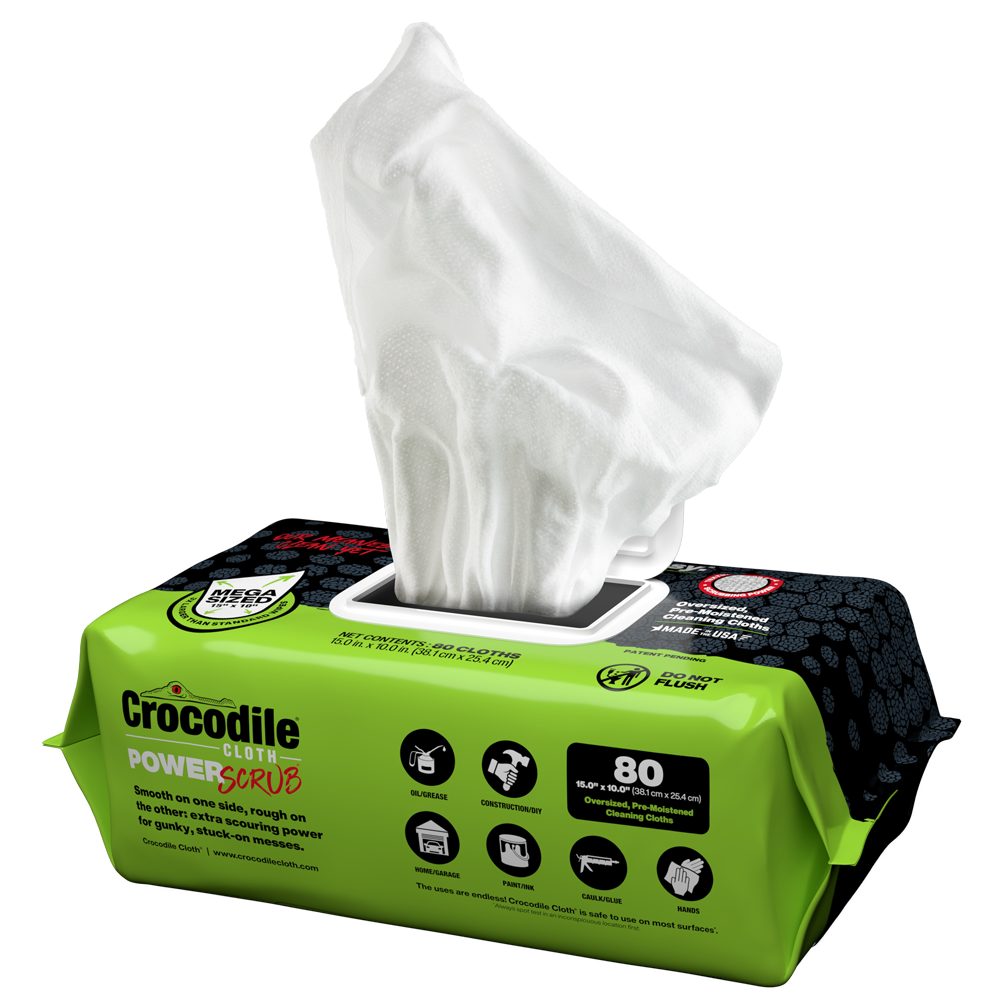 Green packaging of Crocodile PowerScrub with white cloths on a white background
