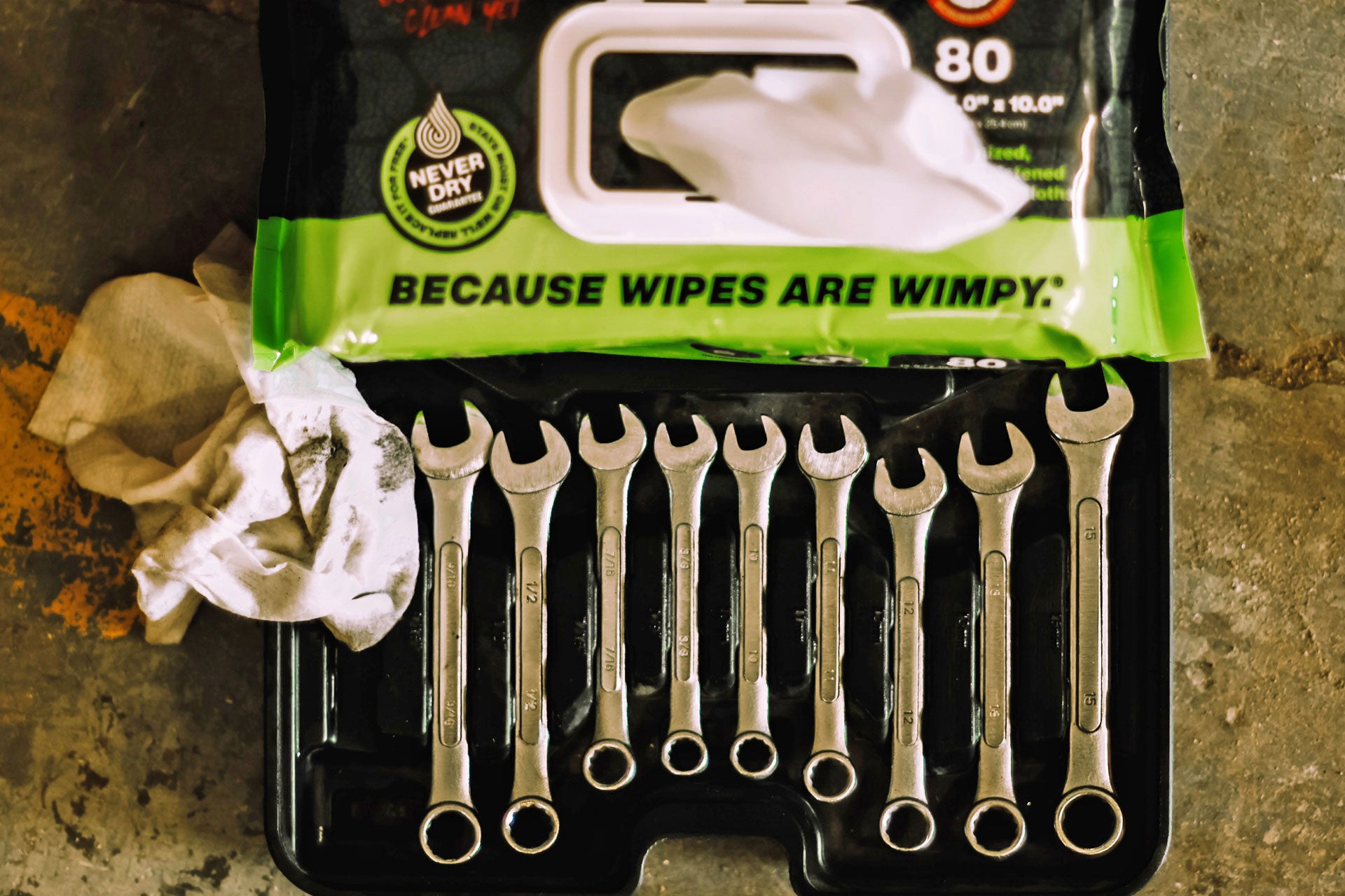 Set of wrenches in a black case with a green label on a textured surface.