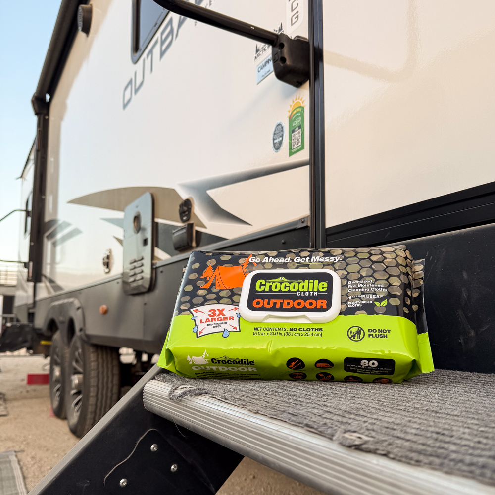 Outdoor 80 pack resting on steps of camper/RV
